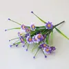 Flor artificial al por mayor hierba acuática plástico hierba de primavera flor Violeta acabado impresión serigráfica flor pequeña Margarita flor falsa accesorios decorativos Flor
