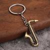 Transfronteiriço atacado mini instrumento musical miniatura brinquedo saxofone mini metal chaveiro pingente de presente de música