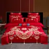 Nuevo conjunto de boda de cuatro piezas 100% algodón bordado 2026, con un diseño lujoso y elegante de algodón de fibra larga, en estilo chino tradicional y color rojo vibrante para bodas