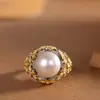 El carácter plata S925 plata seda incrustado perla anillo marea nacional flor temperamento artístico lujo atmosférico pendientes