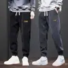 Pantalones Deportivos para Hombres Adolescentes 2025 Nuevo Primavera y Otoño Ajuste Holgado Patchwork Puños Pantalones Largos Casuales Pana Pantalones de Chándal