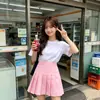 Falda plisada blanca de tiro alto con shorts de seguridad incorporados para evitar la exposición, falda corta versátil de estilo preppy, disponible para venta al por mayor