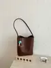 Bolso de textura tejida de nicho de alto valor transfronterizo para mujer 2026 estilo retro nuevo moda bandolera bolso cubo de un solo hombro moderno