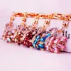 Joyas de cristal pedrería cisne blanco llavero de coche accesorios para bolso de mujer llavero colgante de metal pequeño regalo 1137