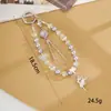 Nuevo colgante de manzana y mariposa con cuentas hecho a mano para teléfono, con un toque de alta gama, charm de cadena doble para bolso, cadena para colgar el teléfono, regalo