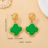 Pendientes de botón de trébol de cuatro hojas dorados martillados de lujo ligero francés de alta venta transfronteriza, adornos para orejas negros y verdes, pendientes versátiles para el commute para mujer