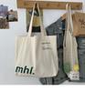 Bolso de lona informal, sencillo y versátil, de estilo coreano, nuevo y versátil, para estudiantes, de gran capacidad, con letras y bandolera.