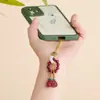 Al por mayor Mineral Crudo Natural Alto Contenido Cinabrio Oro Púrpura Amuletos para Teléfono Retorcidos a Mano, Bolsas de la Suerte, Llaveros, Colgantes para Bolsos, Artículos Populares