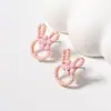 Pendientes de botón de aleación con cabeza de conejo de dibujos animados dulces y lindos estilo coreano con cuentas de arroz, pendientes simples, frescos y versátiles