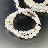 Joyería de flores negras directa de fábrica, cuentas sueltas de ágata oceánica, cuentas redondas, accesorios de pulsera DIY, cuentas semiacabadas al por mayor