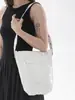 Bolsa de balde casual de grande capacidade para mulheres, novo modelo outono 2026, alto valor estético, cor sólida, design de rebite, bolsa de ombro simples para o dia a dia