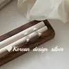 Pendientes de botón de plata estilo coreano, diseño de nicho Ins, plata de ley S925, exquisita flor de trompeta tridimensional con un toque de alta gama para el trabajo