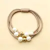 Cuerda de perlas de cabeza múltiple versión coreana de banda elástica perla Joker Corea del Sur perlas doradas cuerda de pelo de nueve perlas anillo de pelo anudado de temperamento venta al por mayor