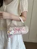 2026 Verão Novo Estilo Exquisite Bolsa de Mão com Laço Feminina Bolsa de Ombro Transversal Pingente Fofo Atacado Bolsa Feminina