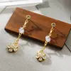 Pendientes de Cobre Incrustados con Zirconio Elegantes de Nicho Transfronterizos Pendientes de Borla de Perla con Rostro de Diosa Adelgazante Accesorios de Flor y Moño