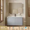 Tocador de baño engrosado y ahorrador de espacio con diseño en color crema, que cuenta con un lavabo redondeado, lavabo cerámico integrado y un lavabo de una sola pieza.