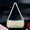 Nova Bolsa de Mão Elegante de Pérolas Artificiais para Mulheres Bolsa de Ombro Versátil Moderna Simples Tecida Bolsa de Ombro Único