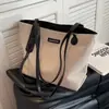 Bolsa feminina casual de grande capacidade 2025 primavera/verão nova bolsa versátil de lona bolsa de ombro para o dia a dia bolsa tote simples