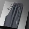 Nuevos pantalones cortos de verano para hombre estilo americano, marca de moda, diseño fino, nicho, corte holgado, talla grande, pantalones casuales deportivos hasta la rodilla