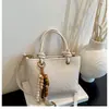Bolso de mano de nicho transfronterizo, bolso tipo cubo para mujer, nuevo, textura tejida retro, bolso para ir al trabajo, elegante bolso de un solo hombro cruzado