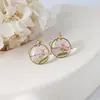 Aretes exquisitos de flor real de venta caliente transfronteriza resina gota pegamento joyería de flor seca aretes nomeolvides joyería artesanal al por mayor
