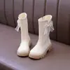 Botas de cuero altas y cálidas, botas estilo Martin para niñas y niños, botas de felpa con suela suave, estilo princesa, de algodón, antideslizantes, con moño, para invierno