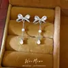 Pendientes de perla con lazo de circón y aguja de plata, elegantes y de moda, versátiles para ir al trabajo, sensación de lujo ligero y alta gama, pendientes al por mayor