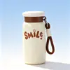 Nueva y elegante taza de bolsillo mini y portátil para mujer, hecha de acero inoxidable 316, con una correa para llevar