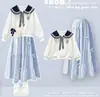 Conjunto de duas peças estilo preppy para meninas para o início do outono: moletom estiloso com gola Peter Pan, laço e saia branca em camadas
