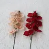Flor artificial 7 cabezas Phalaenopsis flor de boda decoración de fondo comercio exterior al por mayor flor de seda decoración de mesa europea atuendo suave