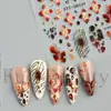 Nuevas pegatinas de arte para uñas transfronterizas, con diseños 3D en relieve, un patrón floral degradado retro rojo y negro, y detalles de lámina dorada, con parte trasera adhesiva para una fácil aplicación