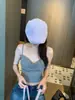 Elegante top tipo camisola de color liso con escote bajo y nudo retorcido, con copas incorporadas, un top que estiliza y realza la figura para un look chic y sexy
