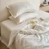 Juego de cuatro piezas de Tencel austriaco Lenzing lavado a la arena de Clase A de alta gama, ropa de cama de Lyocell de color liso bordado simple con una sensación lujosa