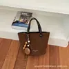 Bolso tipo cubo de estilo retro para mujer, nueva colección otoño 2026, bolso de hombro simple y casual con diseño coreano
