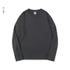 Camiseta básica de manga larga de color liso en stock para venta al por mayor, nuevo modelo de otoño 2026, algodón puro, camiseta base holgada tipo pullover para hombre