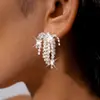Aretes de borla de fuegos artificiales con incrustaciones de diamantes y aguja de plata, súper etéreos y deslumbrantemente hermosos, lujo ligero con un toque de alta gama, aretes versátiles para mujer, venta al por mayor