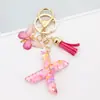 Venta Caliente Transfronteriza a-z Resina Letra Inglesa Lentejuelas Llavero Mariposa Rosa Borla Colgante Colgador de Mochila Mujeres