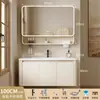 Tocador de baño engrosado y ahorrador de espacio con diseño en color crema, que cuenta con un lavabo redondeado, lavabo cerámico integrado y un lavabo de una sola pieza.