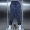 Coleção masculina de primavera da moda: calças casuais de cor sólida, calças jogger de novo estilo, calças slim fit elásticas e versáteis, pretas