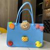 Bolsa de fieltro al por mayor Bola de fieltro Dibujo animado Regalo acompañante Bolso de mano de fieltro Bolsa de compras para llevar a mano Bolsa de regalo logo