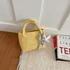 Bolso pequeño de mano simple y elegante para mujer, nuevo artículo de verano 2026, bolso tipo cubo, moderno, color liso, texturizado, bolso cruzado para mujer