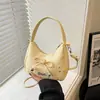 Bolsa de mão leve estilo coreano para mulheres, nova coleção 2026, com design de laço, chique, versátil, moderna e doce, disponível como bolsa de ombro ou bolsa transversal, atacado