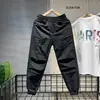 Moda de Verano Estilo Británico Holgado Funcional Diseño Patchwork Pantalones Casuales Verano Secado Rápido Frescos Pantalones Harem para Hombre Modernos
