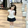 Estilo Coreano Niñas Verano 2026 Nuevo Blanco Encaje Cuello Muñeca Mangas Abullonadas Blusa y Falda Plisada de Lunares