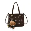 Moderna colección de otoño 2026 para mujer, estilo caricatura minimalista, bolso de hombro, bolso de mano y bolso cruzado de alta gama y único para el trabajo.