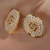 [Baño de oro real] Corea del Sur aretes simples de perla estilo Chanel estilo frío lujo ligero diseño avanzado [Protección ambiental