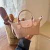 Bolso cruzado tejido de diseño de nicho nuevo 2026, bolso de mano versátil casual para mujer, estilo albóndiga