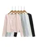 Conjunto de três peças estilo francês: camiseta de manga longa com cardigã de desejo puro + top tipo camisola + saia evasê de cintura alta elástica
