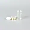 Suministro de fábrica botella transparente de bayoneta regulada con botella de aceite de esencia de arena con tapa de aluminio tapón de goma botella de vidrio