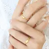 Anillo de amor de viento de metal, diseño de nicho femenino que no se desvanece, anillo hueco chapado en oro, joyería de acero de titanio geométrica de moda